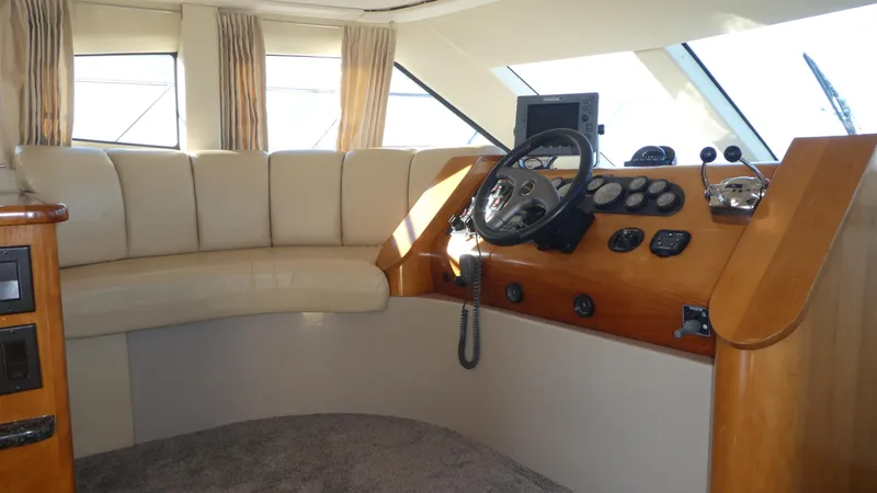 Slide: The Image of Interior of 2005 Carver 38 Super Sport yacht with helm and seating area. - 8