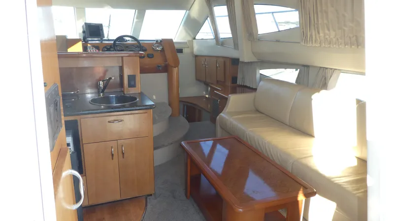 Slide: The Image of Interior of 2005 Carver 38 Super Sport yacht with kitchenette and seating area. - 10