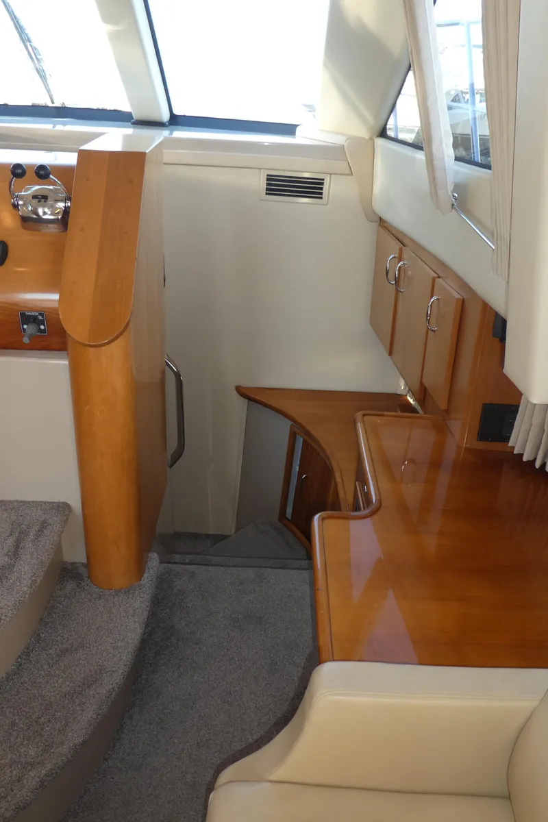 Slide: The Image of Interior of 2005 Carver 38 Super Sport yacht with wood finish and stairs. - 12