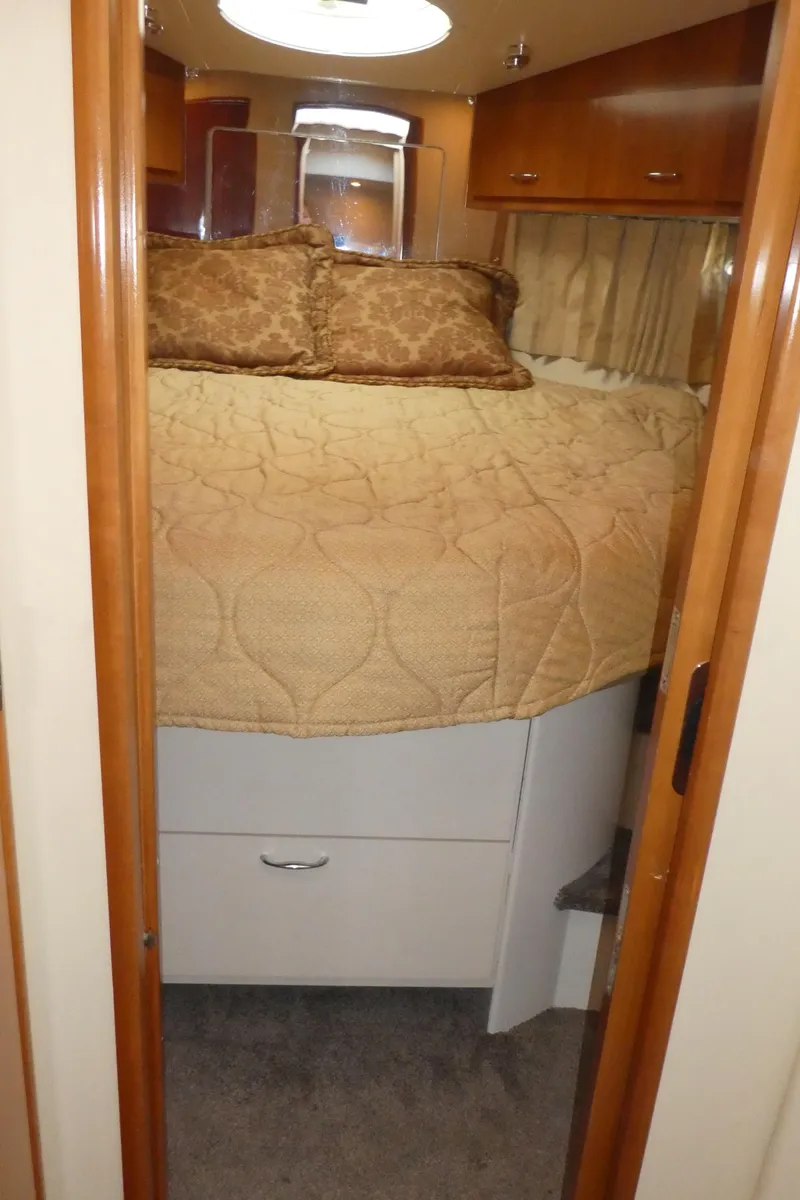 Slide: The Image of Cozy bedroom in 2005 Carver 38 Super Sport yacht with plush bedding and wood accents. - 14
