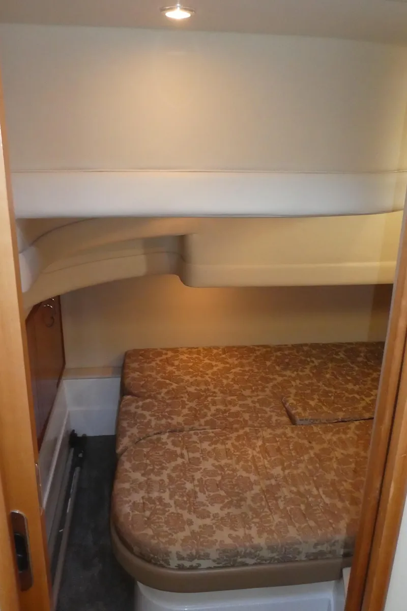 Slide: The Image of 2005 Carver 38 Super Sport cabin with cozy bed and ambient lighting. - 21