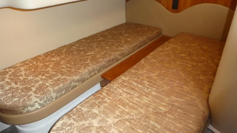 Slide: The Image of 2005 Carver 38 Super Sport cabin with twin beds and patterned bedding. - 23