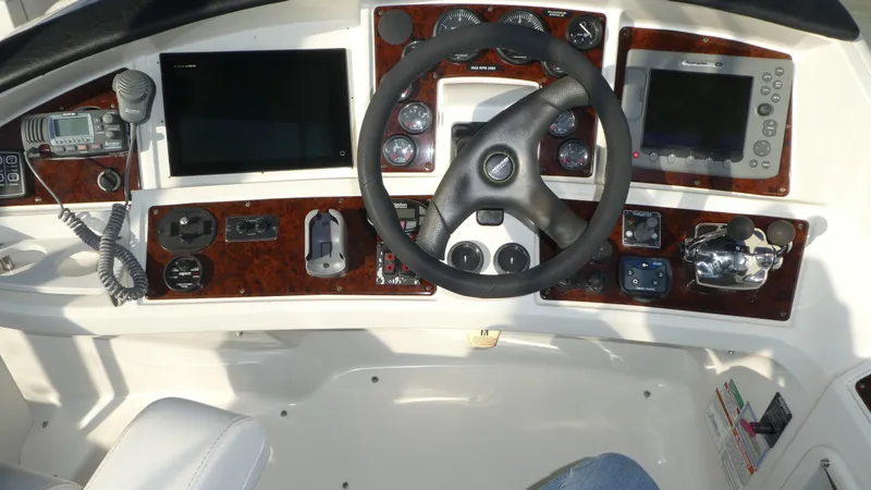 Slide: The Image of 2005 Carver 38 Super Sport helm with steering wheel and navigation controls. - 29