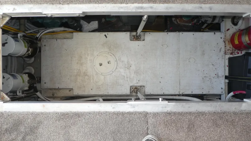 Slide: The Image of Engine compartment of 2005 Carver 38 Super Sport boat, showing mechanical components and wiring. - 34