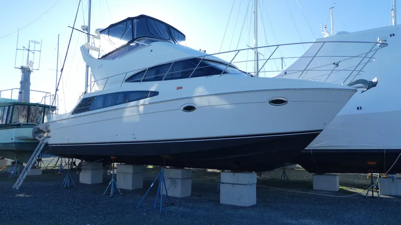 Slide: The Image of 2005 Carver 38 Super Sport yacht on stands in a marina. - 47