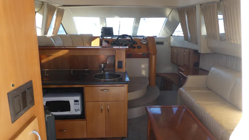 Slide: The Image of Interior of 2005 Carver 38 Super Sport yacht with kitchenette and seating area. - 5