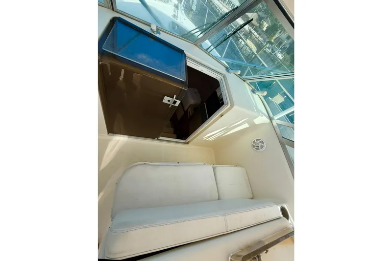 Slide: The Image of 2003 Pursuit 3070 Offshore Center Console cabin interior with seating and storage. - 15
