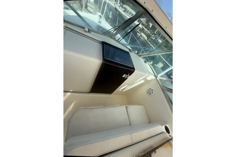 Slide: The Image of 2003 Pursuit 3070 Offshore Center Console interior with seating and storage. - 16