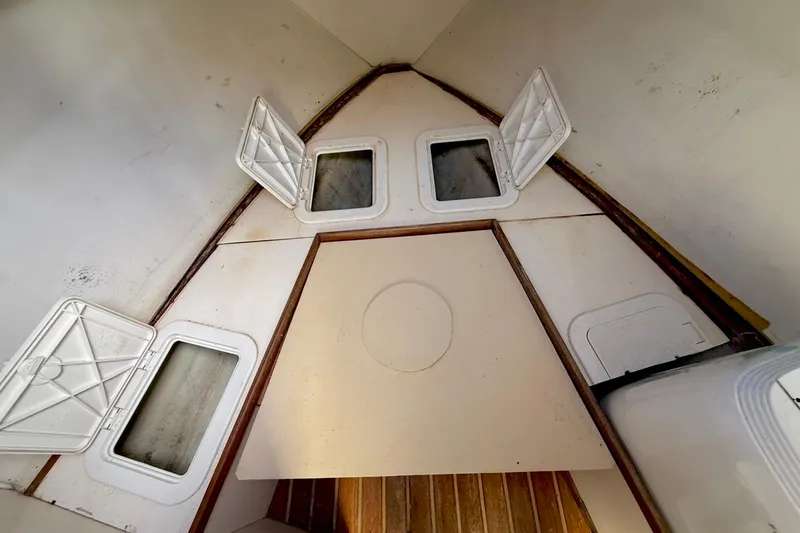 Slide: The Image of Interior view of 2003 Pursuit 3070 Offshore Center Console boat cabin with storage compartments. - 18