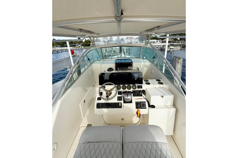 Slide: The Image of 2003 Pursuit 3070 Offshore Center Console boat interior with steering wheel and controls. - 4