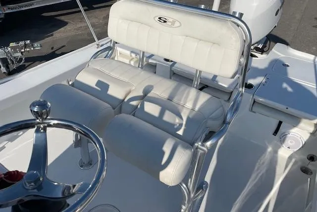 Slide: The Image of 2021 Sea Hunt BX 22 BR boat interior with white cushioned seating and steering wheel. - 11