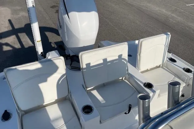 Slide: The Image of 2021 Sea Hunt BX 22 BR boat with white seating and motor, docked on pavement. - 13