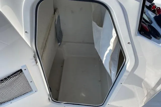 Slide: The Image of 2021 Sea Hunt BX 22 BR boat storage compartment, open and empty. - 15