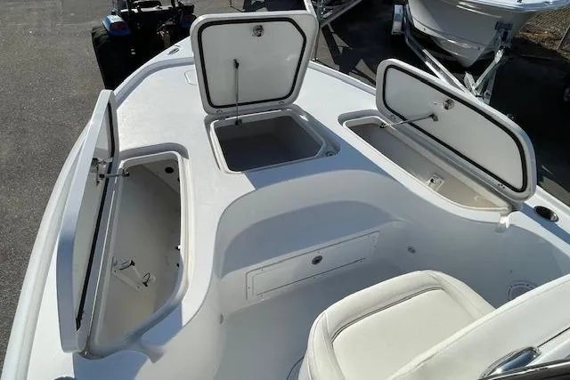Slide: The Image of 2021 Sea Hunt BX 22 BR boat with open storage compartments on deck. - 16