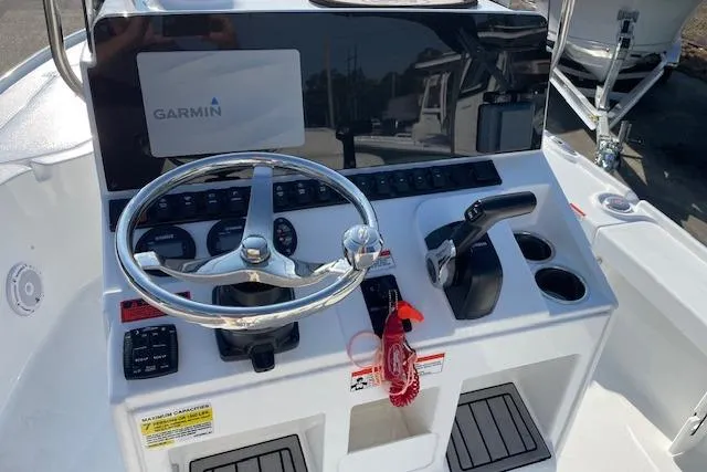 Slide: The Image of 2021 Sea Hunt BX 22 BR boat console with Garmin navigation system and steering wheel. - 5