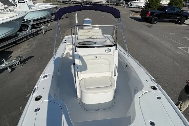 Slide: The Image of 2021 Sea Hunt BX 22 BR boat with seating and canopy, parked on a lot. - 9