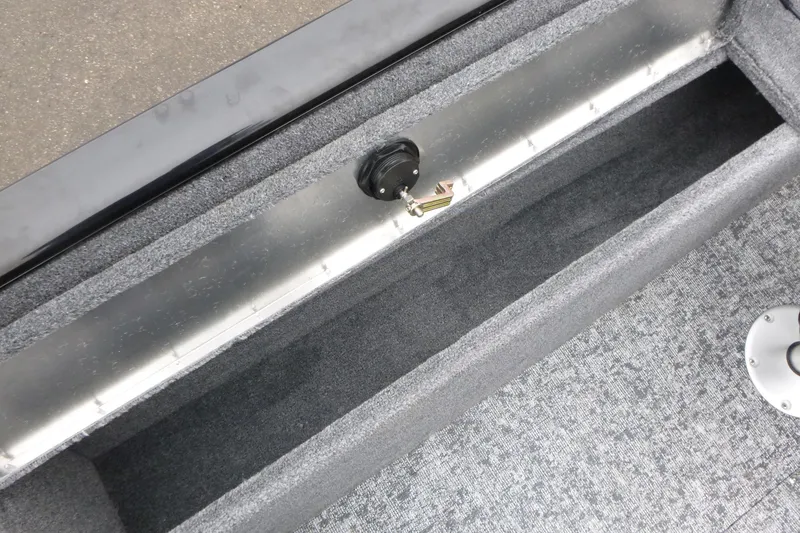 Slide: The Image of 2026 Tracker Pro Guide V-175 WT boat storage compartment with gray carpeted interior. - 10