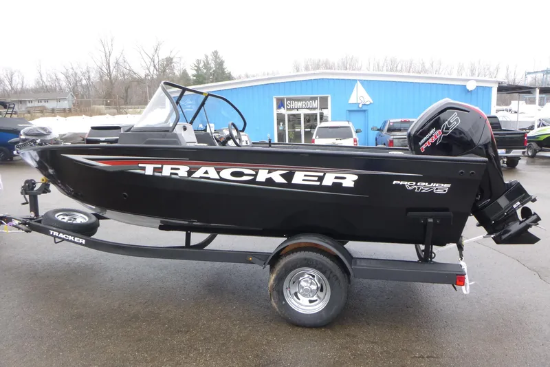 Slide: The Image of 2026 Tracker Pro Guide V-175 WT boat on trailer, parked outside showroom. - 4