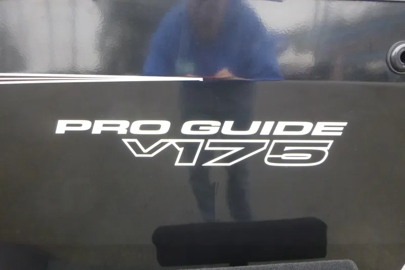 Slide: The Image of 2026 Tracker Pro Guide V-175 WT boat logo on black surface. - 5