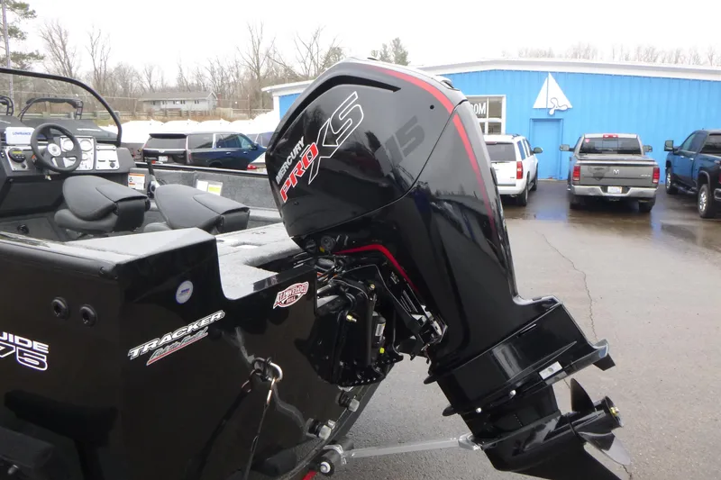 Slide: The Image of 2026 Tracker Pro Guide V-175 WT boat with Mercury Pro XS engine, parked outdoors. - 6