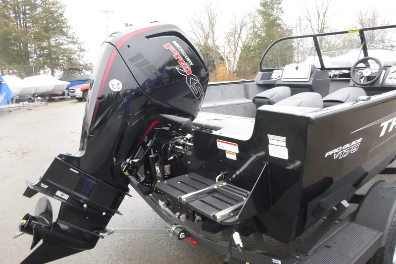 Slide: The Image of 2026 Tracker Pro Guide V-175 WT boat with Mercury 115 engine, parked outdoors. - 7