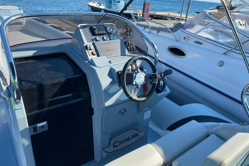 Slide: The Image of Cockpit of 2022 Ranieri CAYMAN 27.0 SPORT TOURING boat, featuring steering wheel and controls. - 12