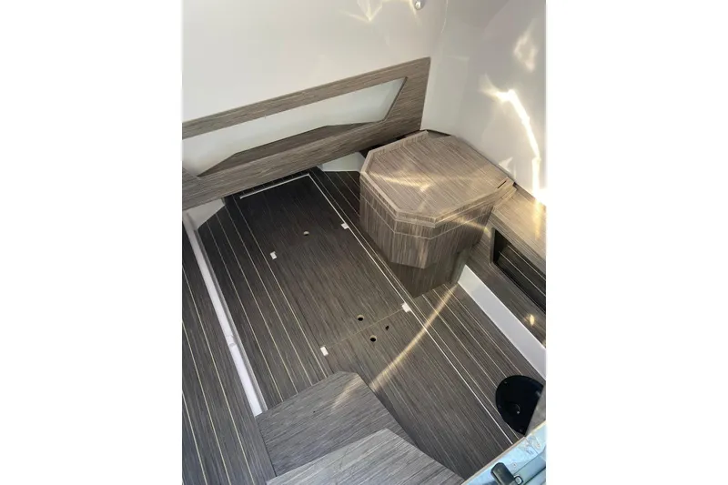 Slide: The Image of Interior of 2022 Ranieri CAYMAN 27.0 SPORT TOURING boat with sleek wood finish. - 13