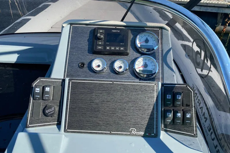 Slide: The Image of Control panel of 2022 Ranieri CAYMAN 27.0 SPORT TOURING boat with gauges and switches. - 14