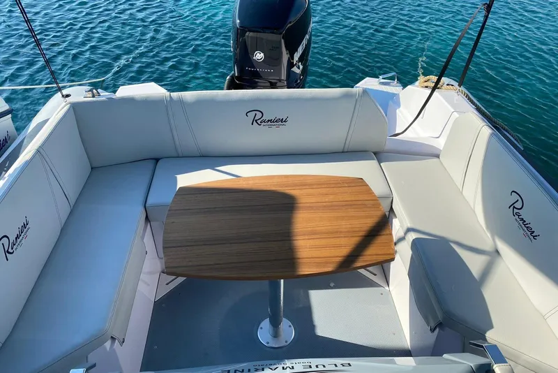 Slide: The Image of 2022 Ranieri CAYMAN 27.0 SPORT TOURING boat interior with seating and table. - 17