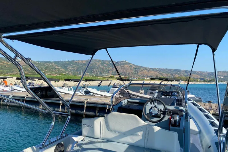 Slide: The Image of 2022 Ranieri CAYMAN 27.0 SPORT TOURING boat docked with scenic mountain backdrop. - 18