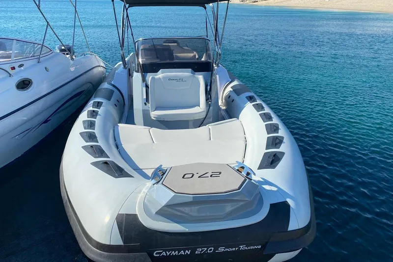 Slide: The Image of 2022 Ranieri CAYMAN 27.0 SPORT TOURING boat on clear blue water. - 2