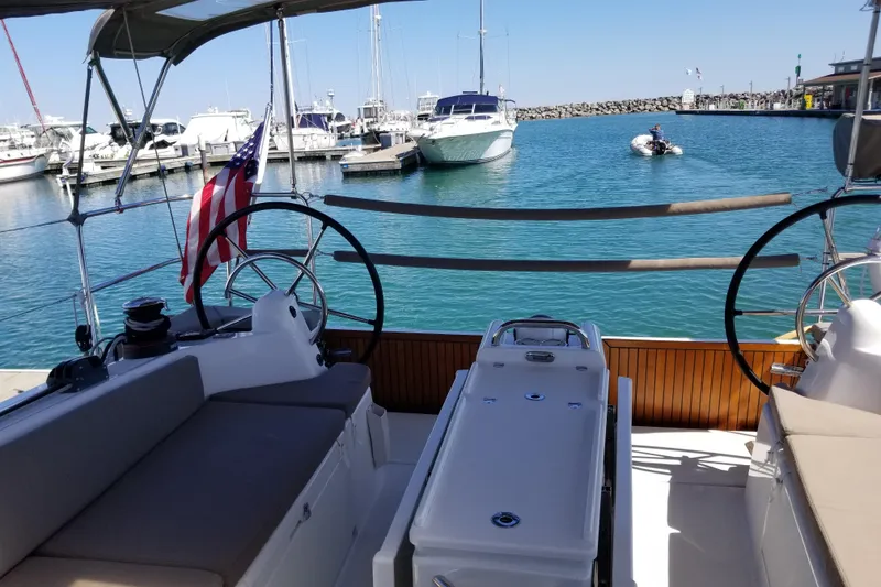 Slide: The Image of Jeanneau Sun Odyssey 410 sailboat, 2020 model, docked in a marina with clear blue water. - 14