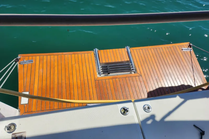 Slide: The Image of Jeanneau Sun Odyssey 410, 2020 model, featuring a wooden swim platform and ladder. - 19