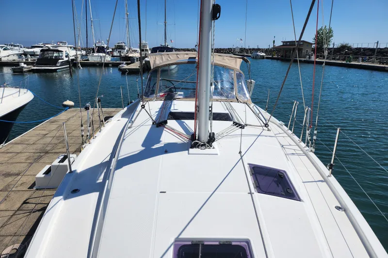 Slide: The Image of 2020 Jeanneau Sun Odyssey 410 sailboat docked in a marina under clear blue skies. - 6
