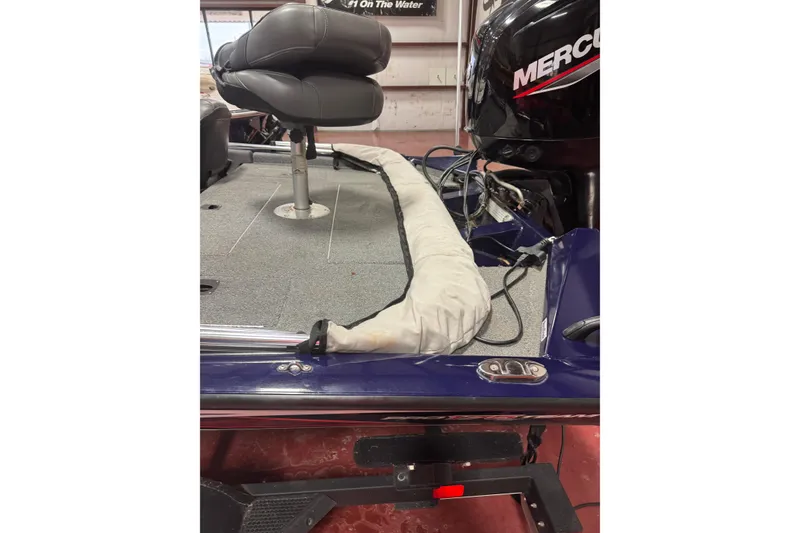 Slide: The Image of 2021 Bass Tracker Pro Team 175 boat interior with Mercury engine and cushioned seating. - 3