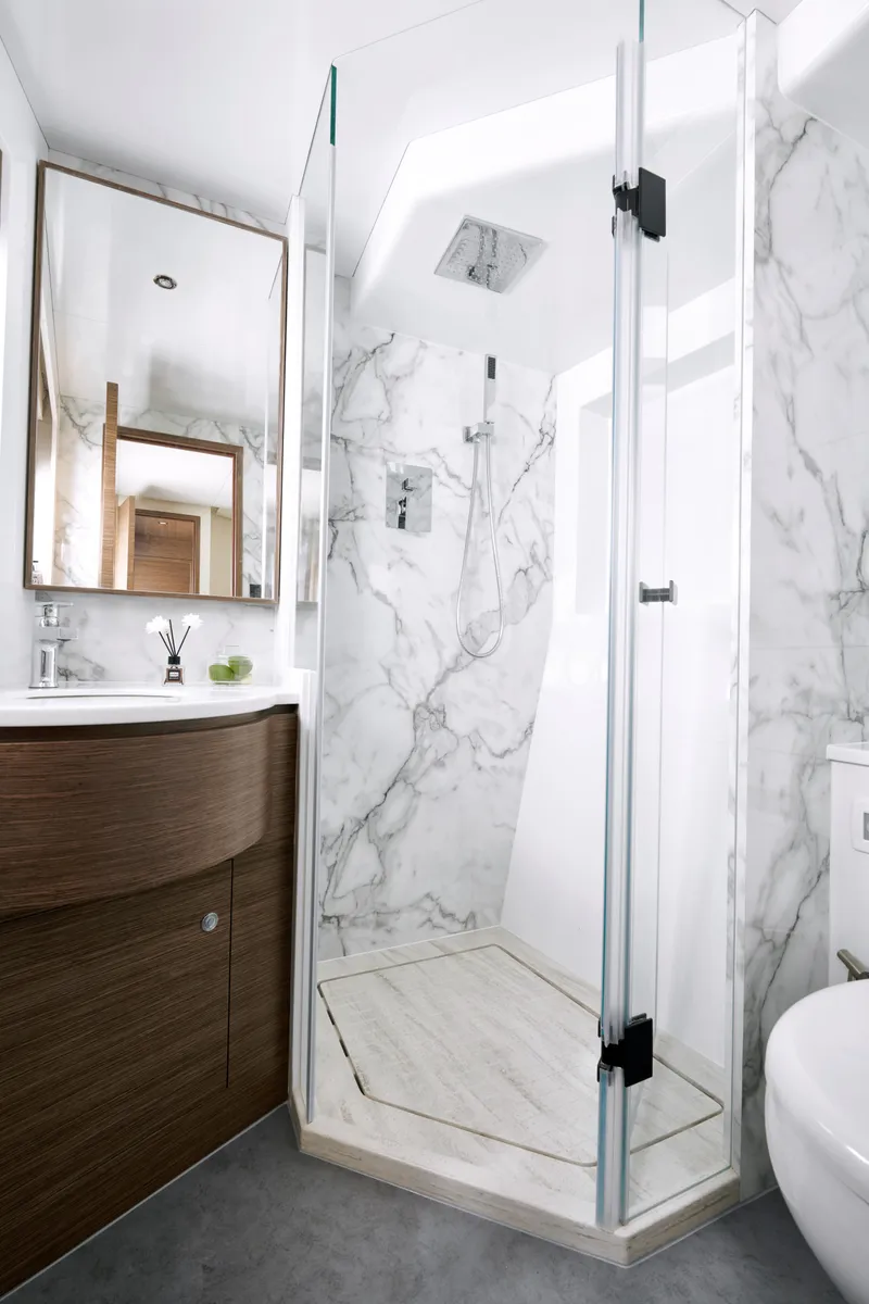 Slide: The Image of Modern bathroom with marble shower, glass door, and wooden vanity in Skywalker S60, 2025 model. - 22