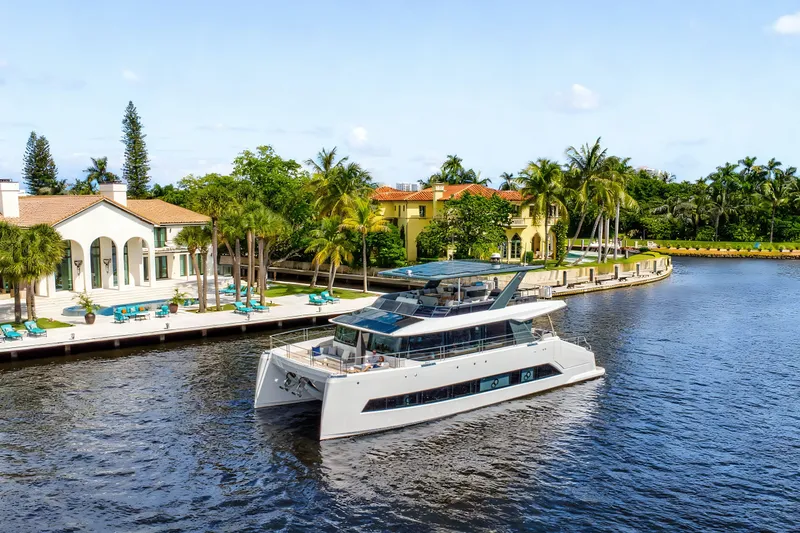 Slide: The Image of Luxurious Oceanwalker S60e electric yacht cruising near waterfront villas, 2026 model. - 3