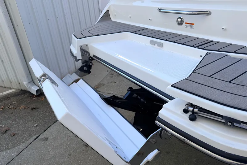 Slide: The Image of 2026 Sea Ray SDX 230 boat with open swim platform and sleek design. - 4