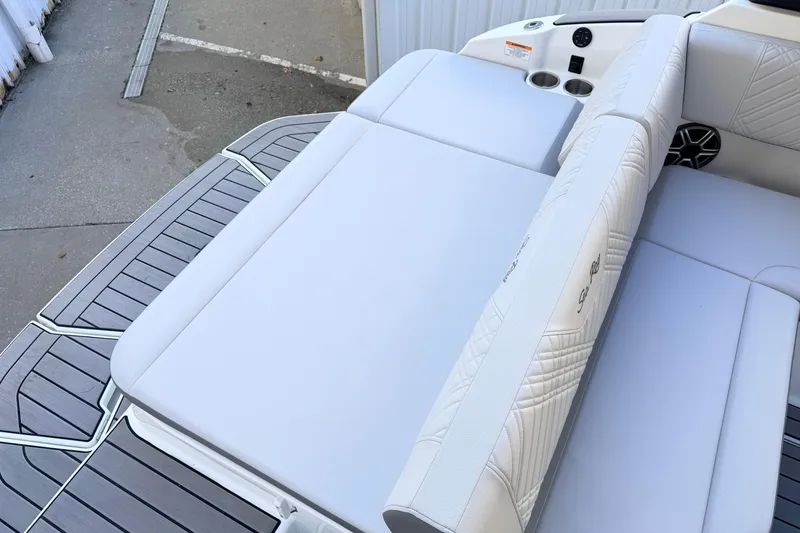 Slide: The Image of 2026 Sea Ray SDX 230 boat with luxurious white seating and sleek design. - 5