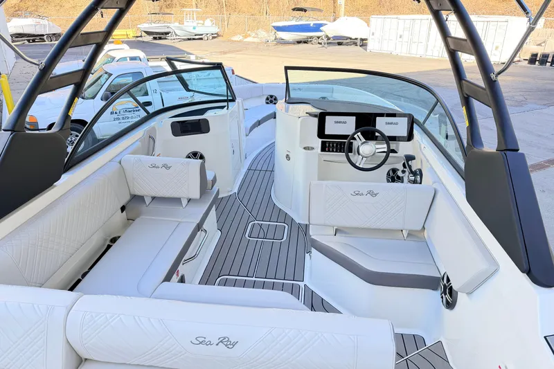 Slide: The Image of 2026 Sea Ray SDX 230 boat interior with modern seating and dual Simrad displays. - 6