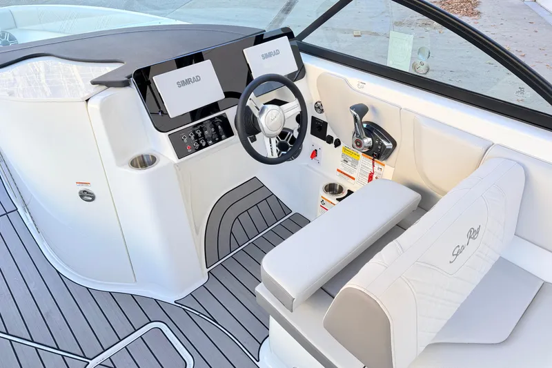 Slide: The Image of 2026 Sea Ray SDX 230 boat cockpit with modern controls and Simrad displays. - 7