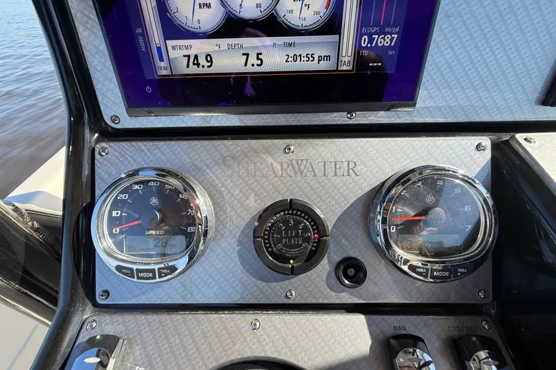 Slide: The Image of Dashboard of 2018 ShearWater 23LTZ boat with speedometer and RPM gauges. - 12