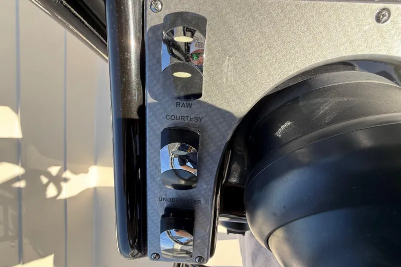 Slide: The Image of Control panel of a 2018 ShearWater 23LTZ boat with labeled switches. - 14
