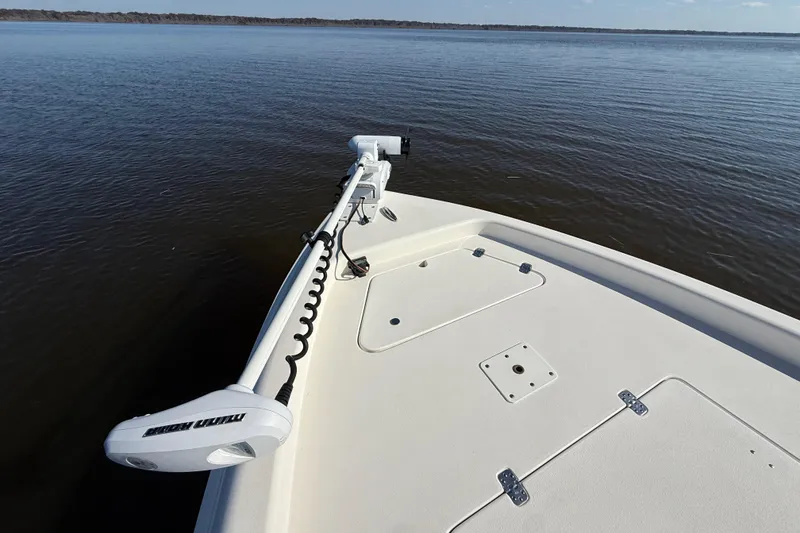 Slide: The Image of Bow of 2018 ShearWater 23LTZ boat with trolling motor on calm water. - 22