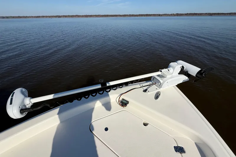 Slide: The Image of 2018 ShearWater 23LTZ boat with trolling motor on calm water. - 23