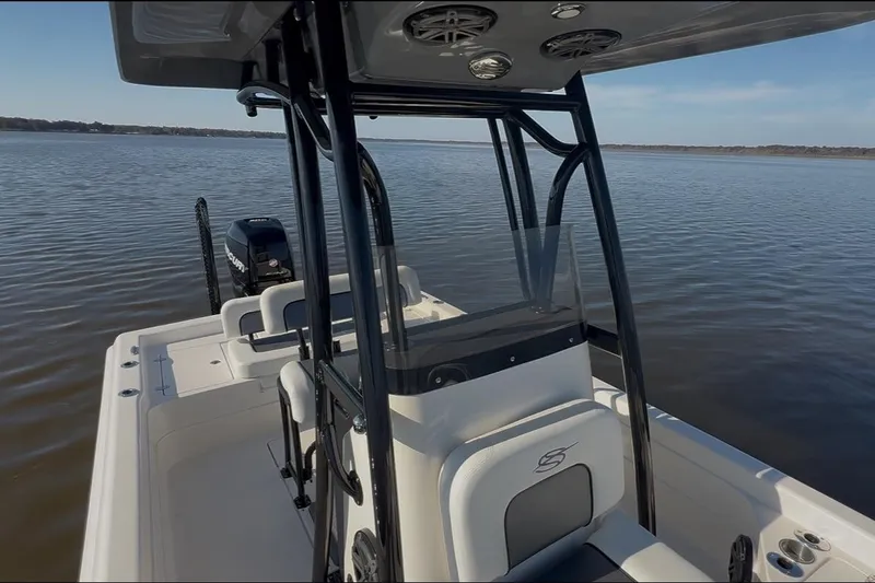 Slide: The Image of 2018 ShearWater 23LTZ boat on calm water, featuring sleek design and modern amenities. - 25