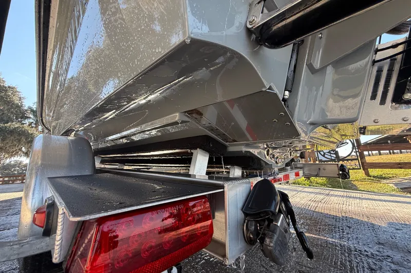 Slide: The Image of 2018 ShearWater 23LTZ boat on trailer, close-up of hull and rear view. - 38