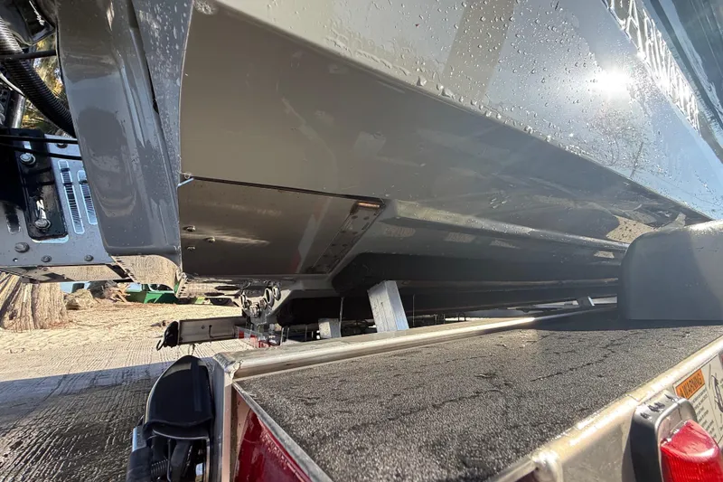 Slide: The Image of 2018 ShearWater 23LTZ boat on trailer, close-up view of hull and rear. - 39