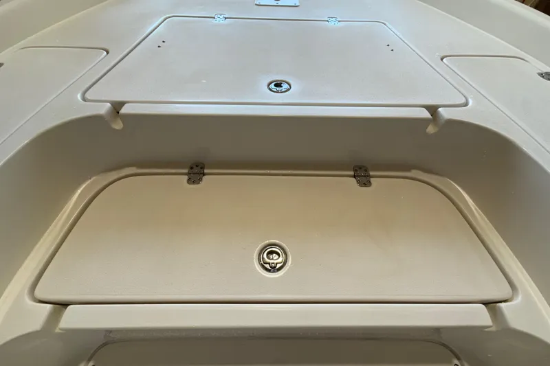 Slide: The Image of 2018 ShearWater 23LTZ boat storage compartments with secure latches. - 42