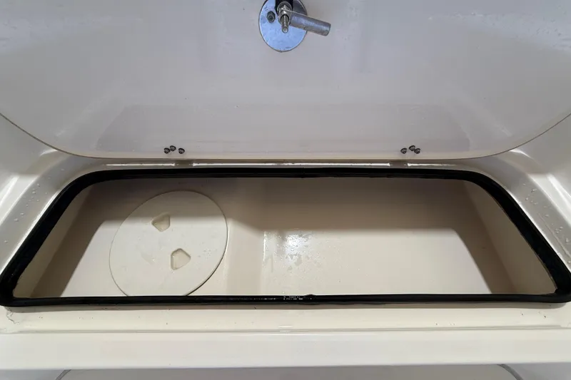 Slide: The Image of 2018 ShearWater 23LTZ boat storage compartment with circular hatch and secure latch. - 43